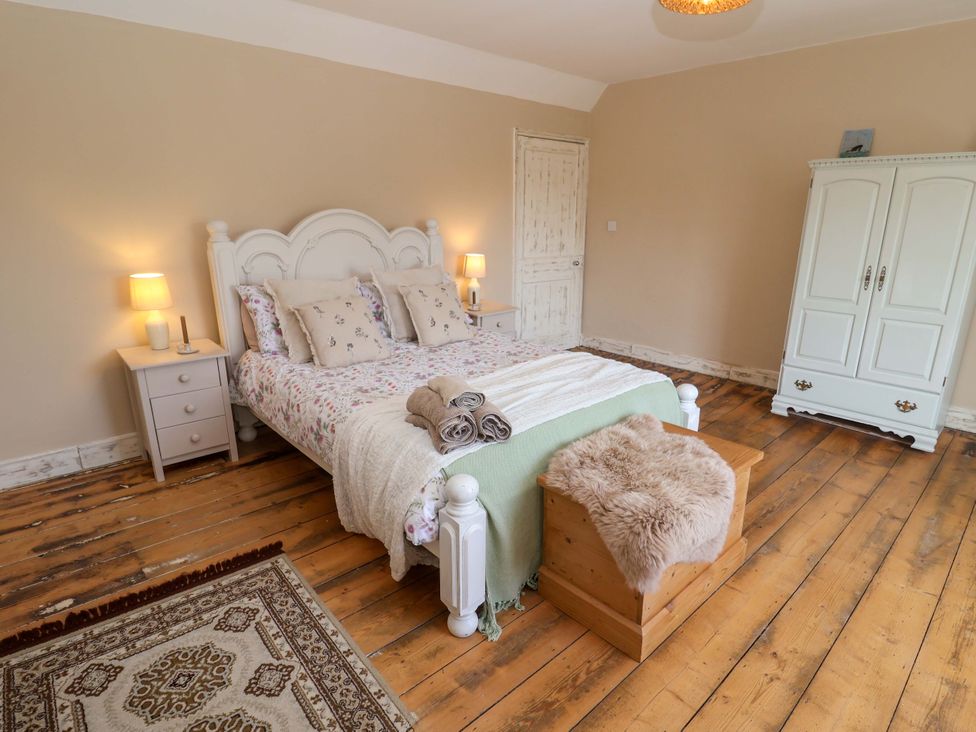 A bedroom with a bed and wardrobe at Beehive in Beccles