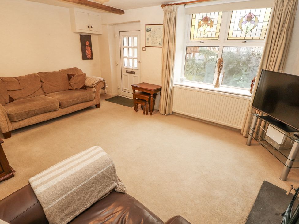 A living room with a sofa and coffee table at 2 Bens Row Backbarrow near Newby Bridge