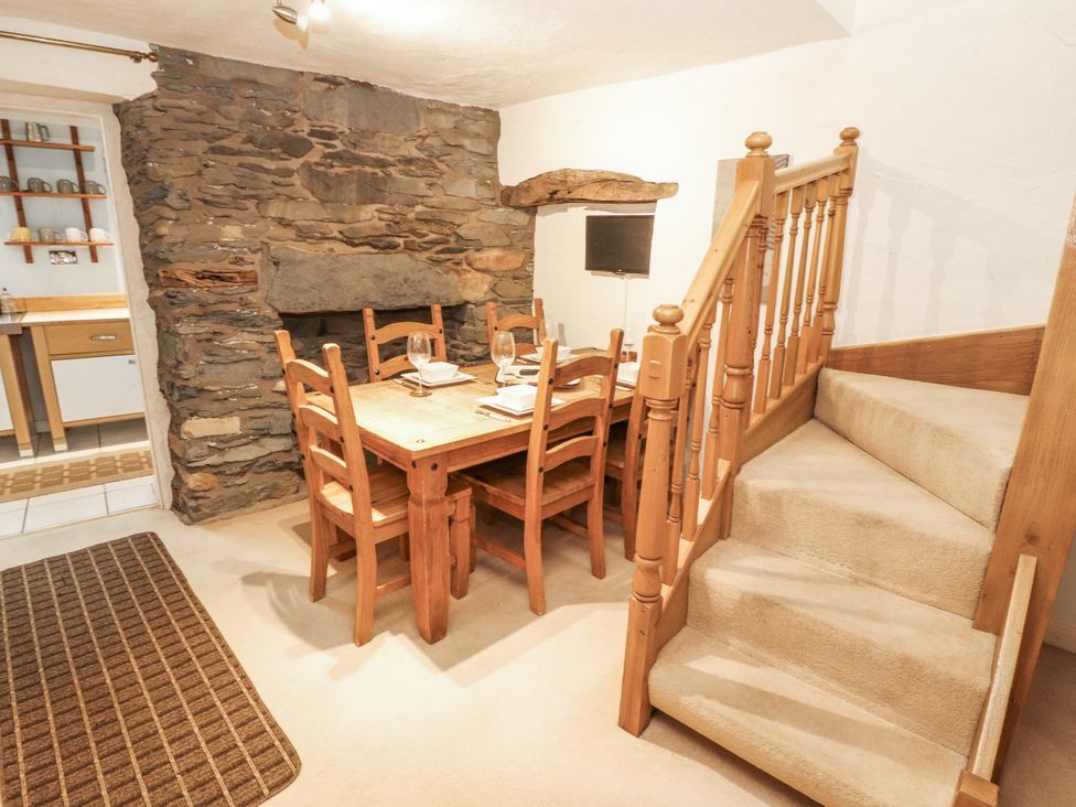 A dining room with a table and chairs at 2 Bens Row in Backbarrow near Newby Bridge