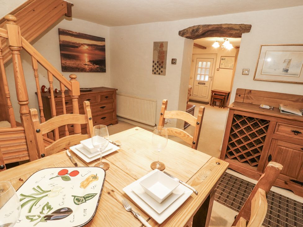 A dining room with a wooden table and chairs at 2 Bens Row Backbarrow near Newby Bridge