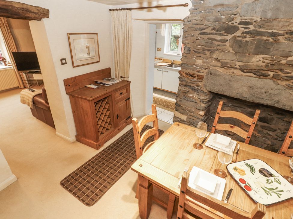 A dining room with a table and chairs at 2 Bens Row Backbarrow near Newby Bridge
