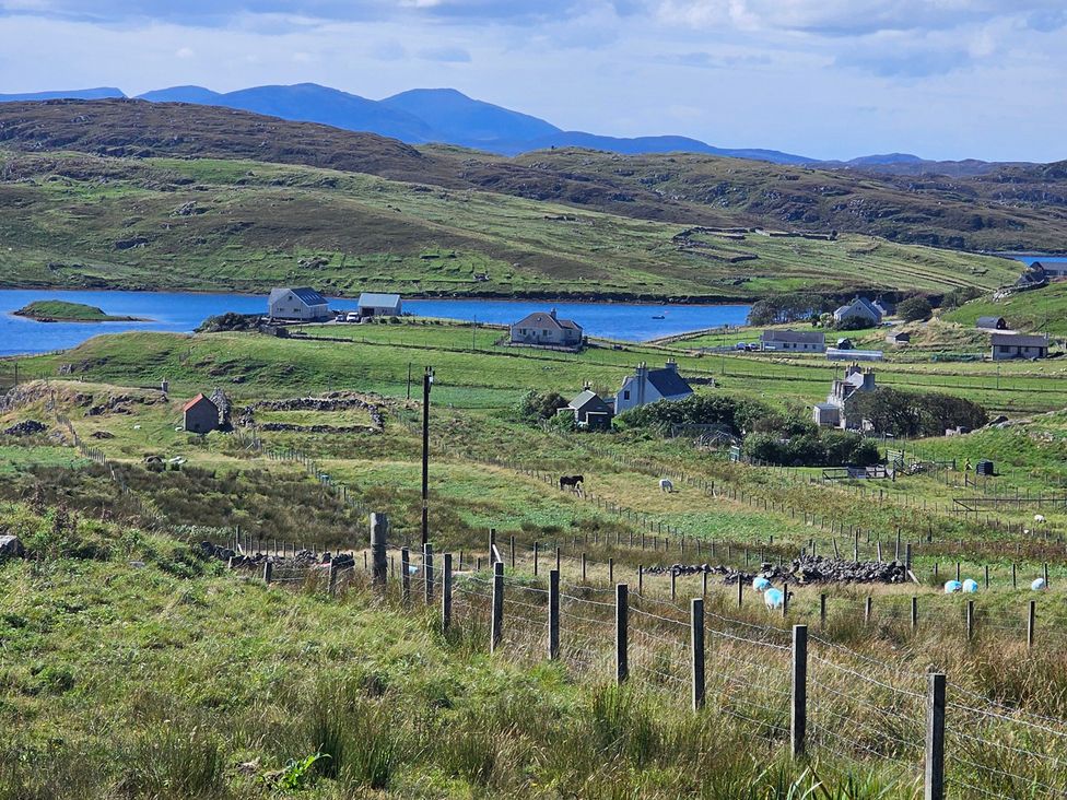 A landscape with houses and fields near a lake at 11 Knock Carloway