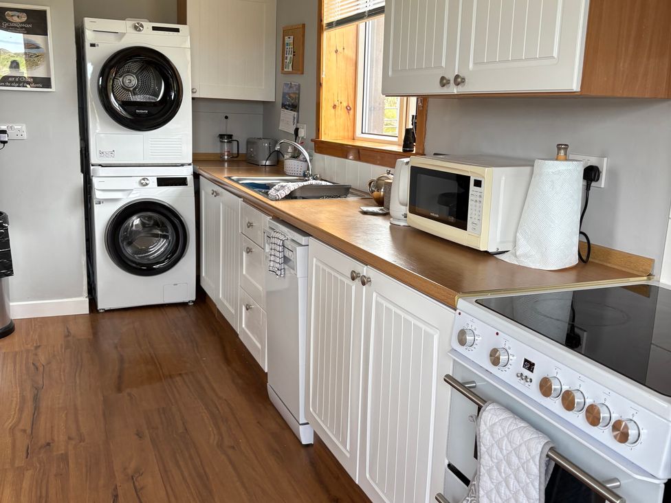 A kitchen with appliances and wooden counter at 11 Knock in Carloway