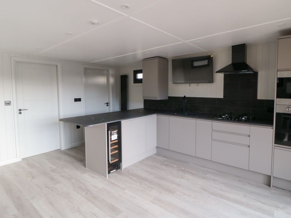 A kitchen with cabinets and appliances at Lodge 1 Yarm