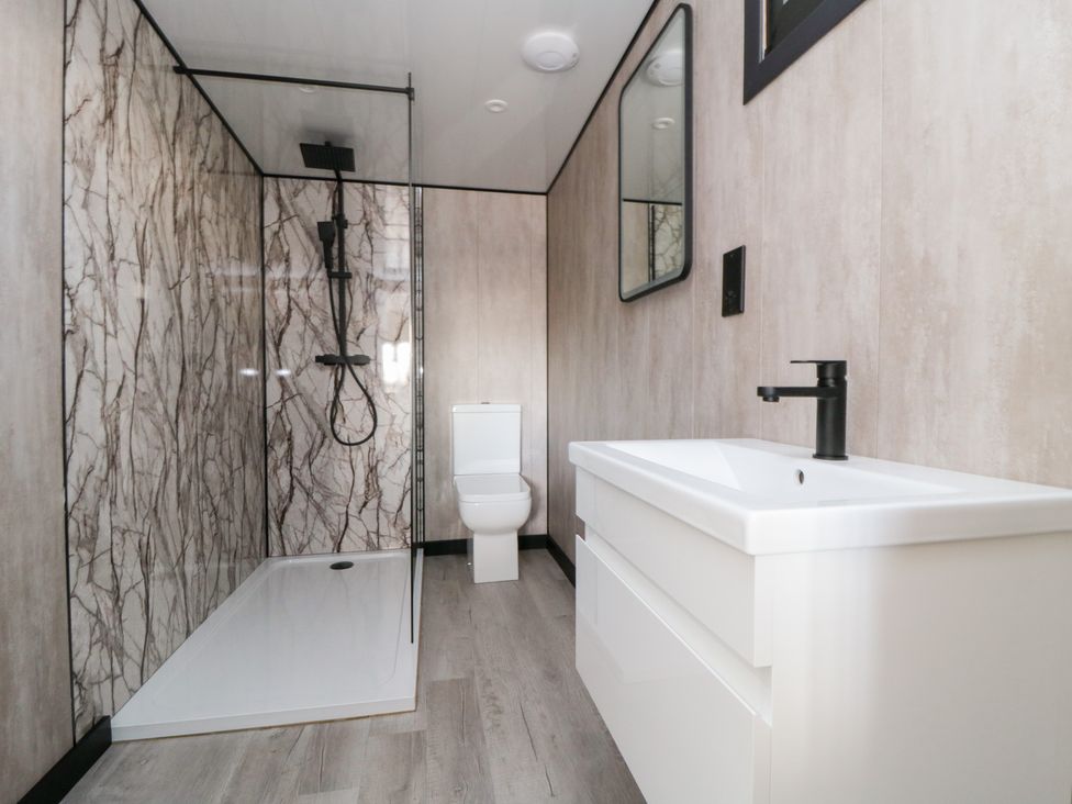 A bathroom with shower, toilet, and sink at Lodge 2 Stockton-on-Tees