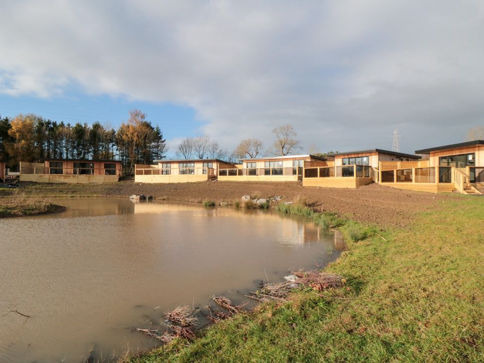 A view of lodges next to a pond at Lodge 3 Stockton-on-Tees