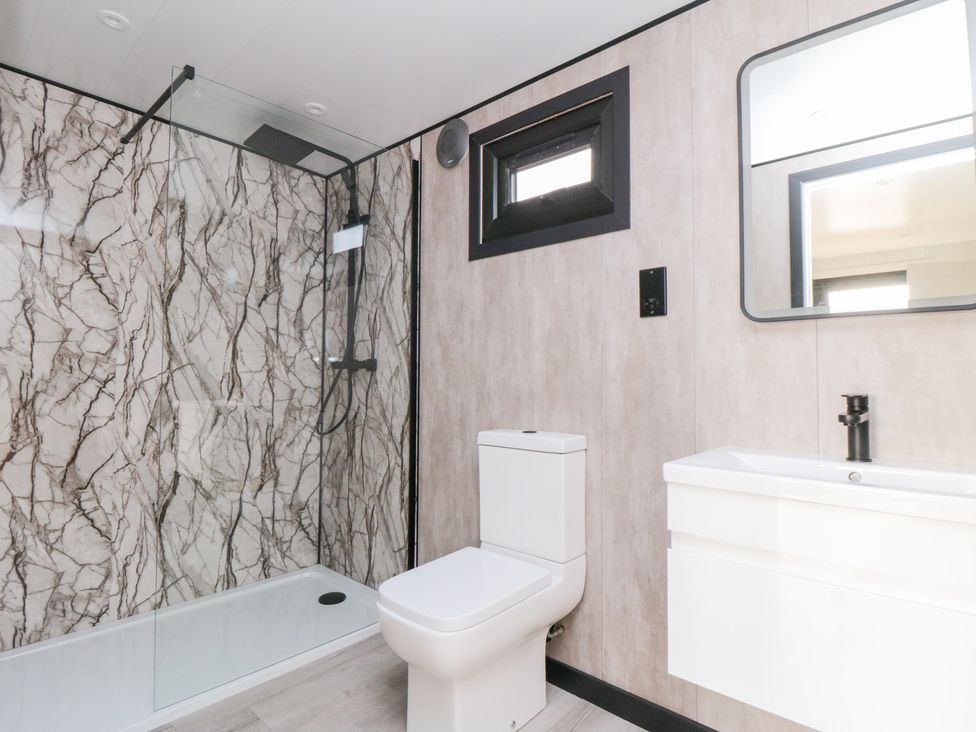 A bathroom with a shower, toilet, and sink at Lodge 4 Stockton-on-Tees