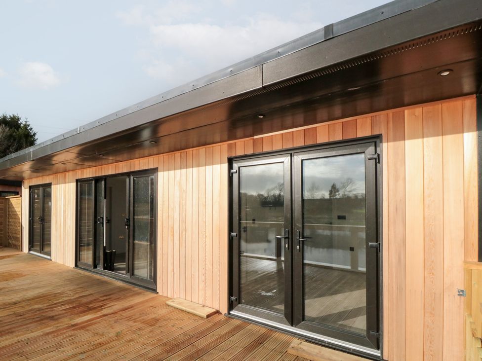 An outdoor view of a wooden building with sliding doors at Lodge 5 Stockton-on-Tees
