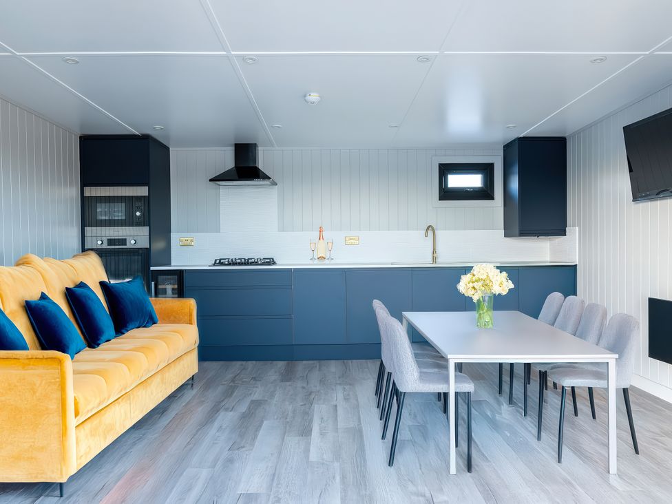 A kitchen with a dining table and chairs at Swan Lake Lodge Yarm