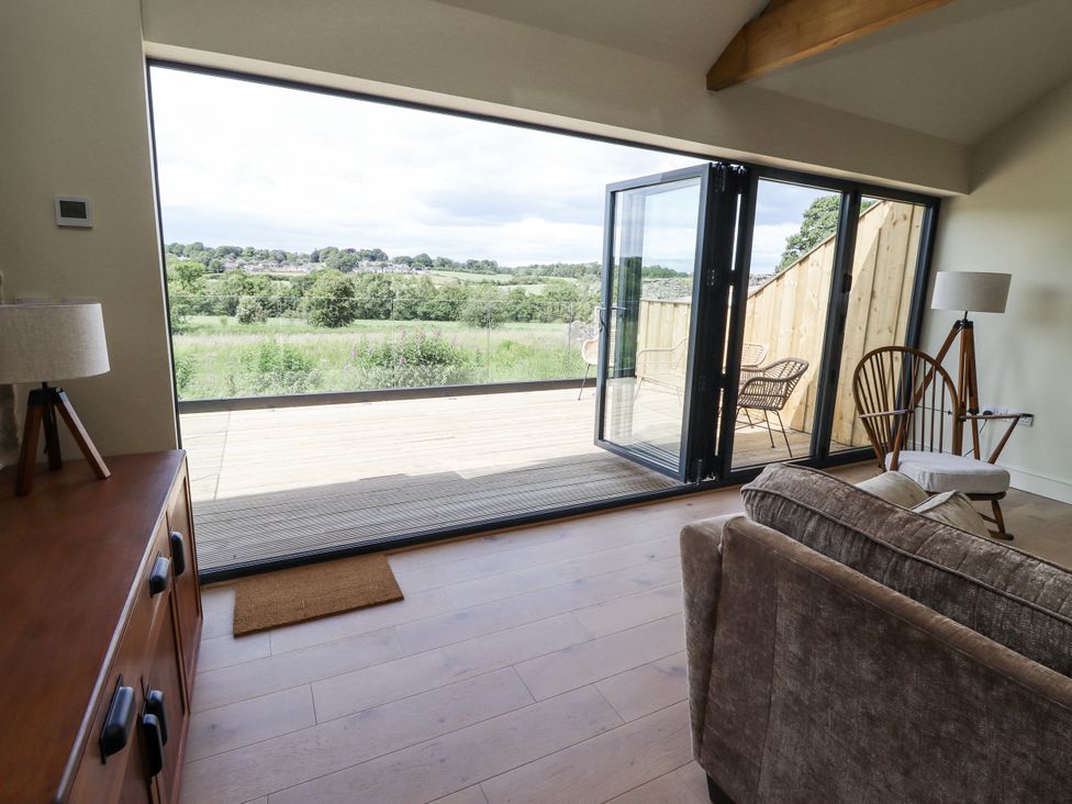 A living room with a view of fields and double doors at West Dunkirk Hemmels Hexham