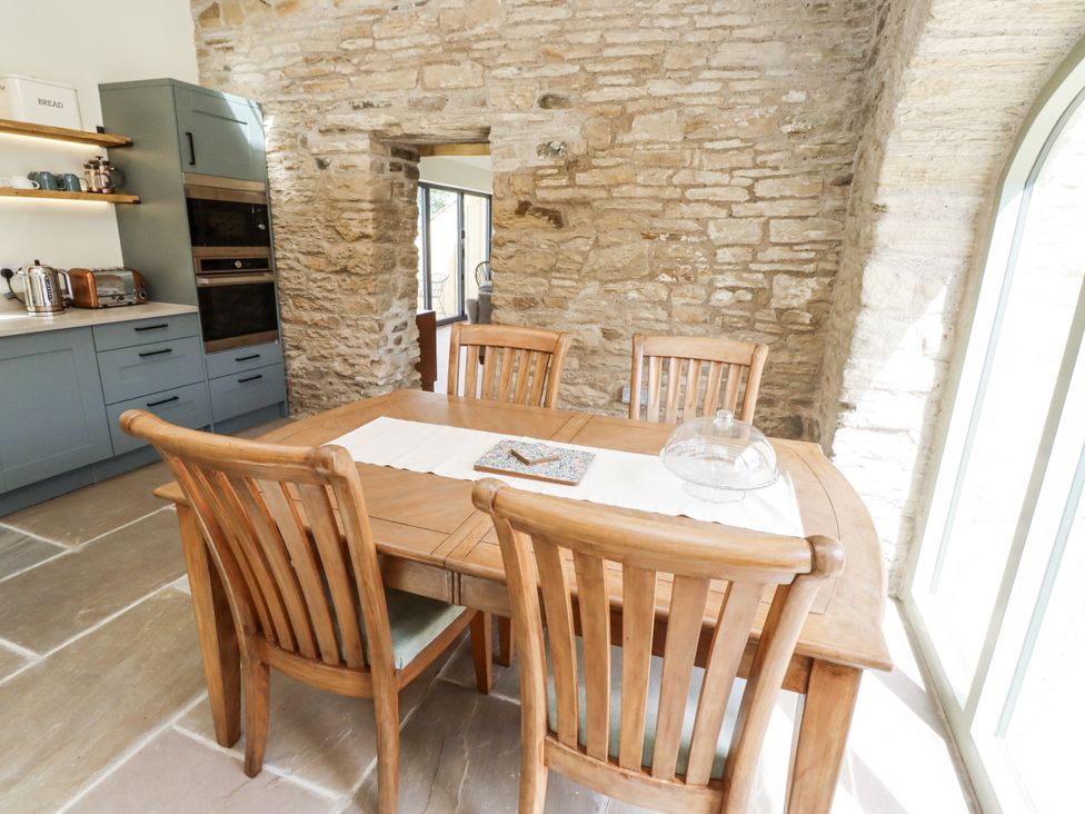 A dining room with a wooden table and chairs at West Dunkirk Hemmels in Hexham