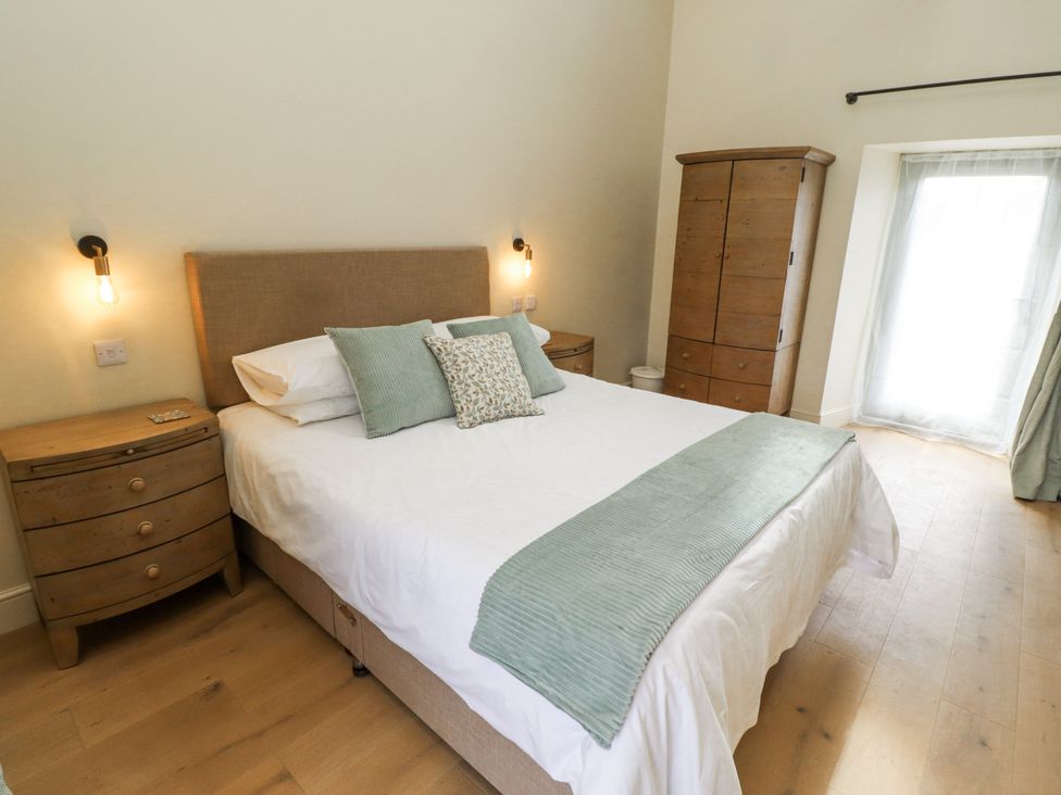 A bedroom with a bed and wardrobe at West Dunkirk Hemmels in Hexham