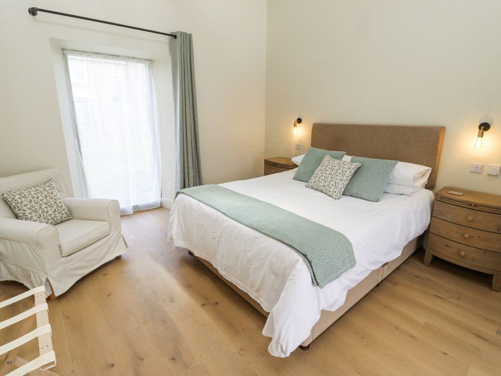A bedroom with a bed and armchair at West Dunkirk Hemmels in Hexham