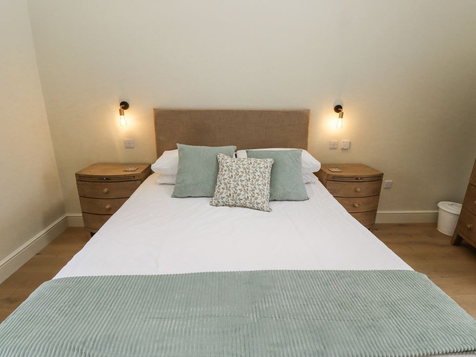 A bedroom with a bed and bedside tables at West Dunkirk Hemmels Hexham