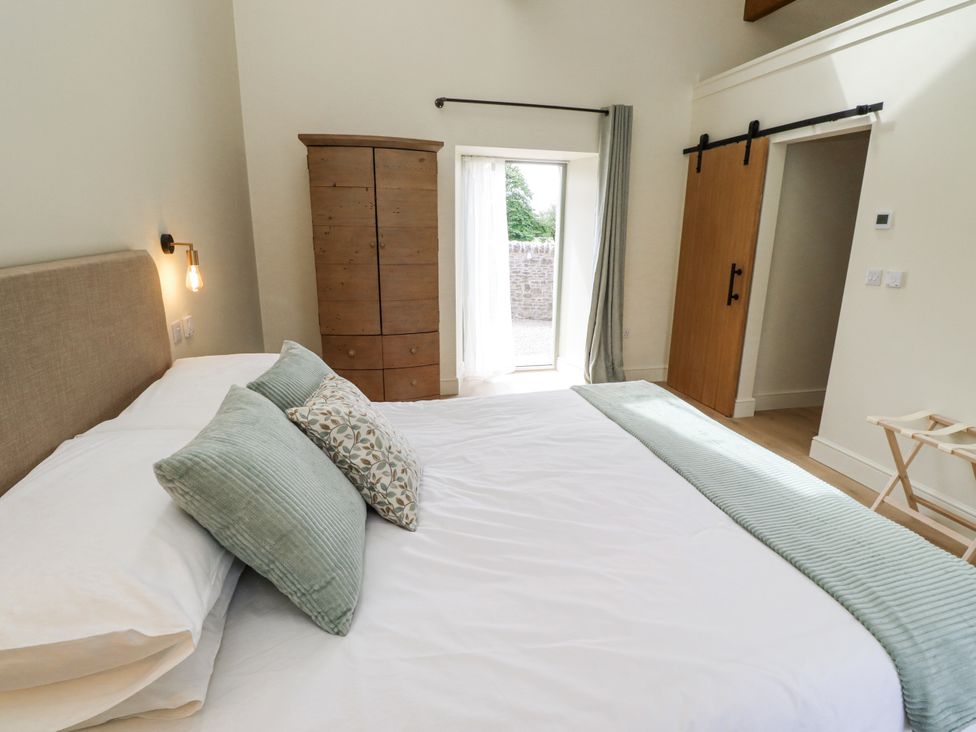 A bedroom with a bed and wardrobe at West Dunkirk Hemmels Hexham