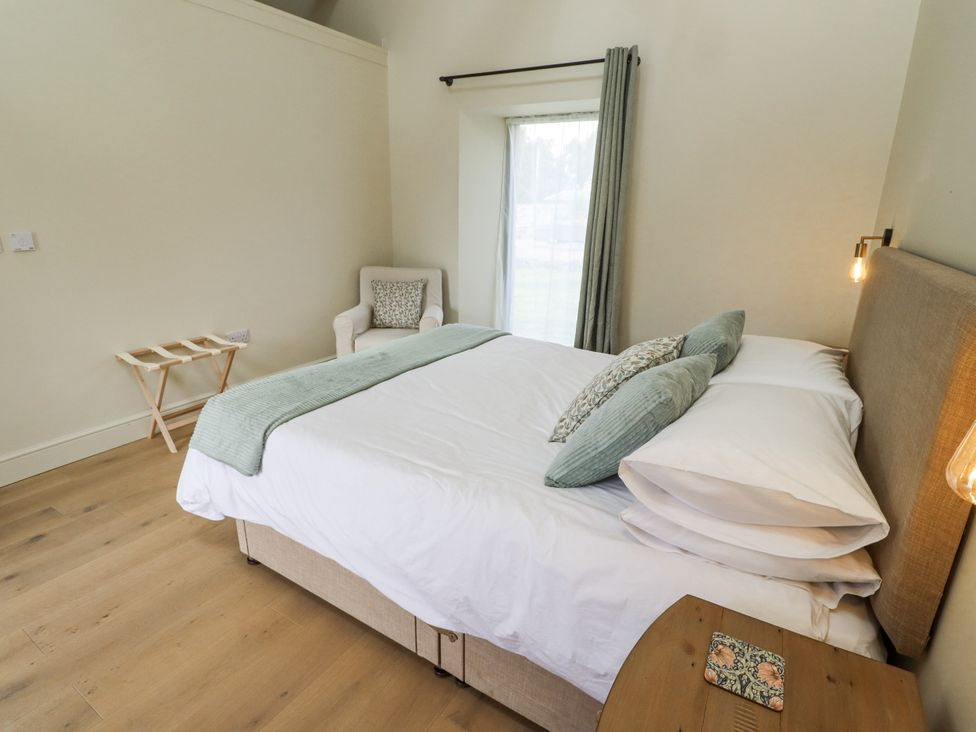 A bedroom with a bed and chair at West Dunkirk Hemmels in Hexham