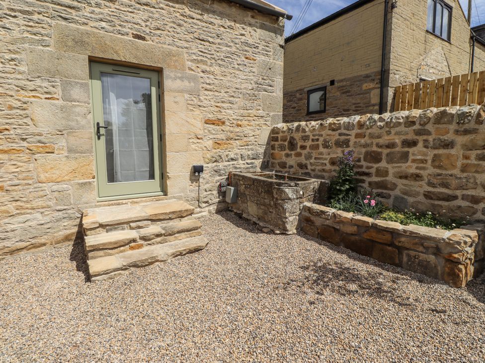 An outdoor space with a door and flower bed at West Dunkirk Hemmels Hexham