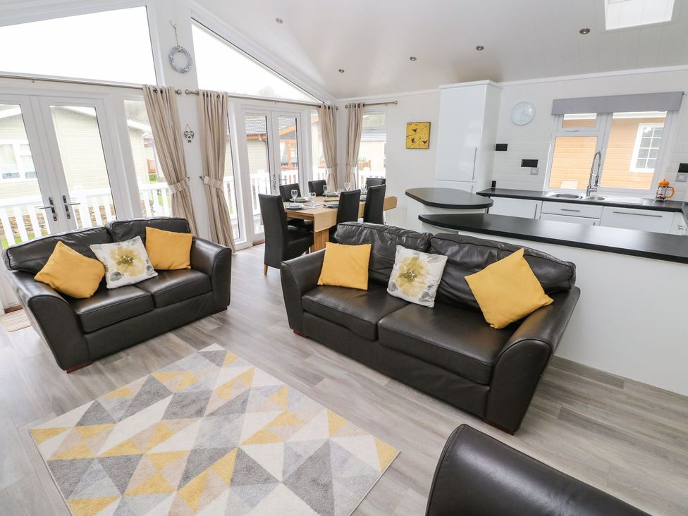 A living room with sofa and dining area at Erisa