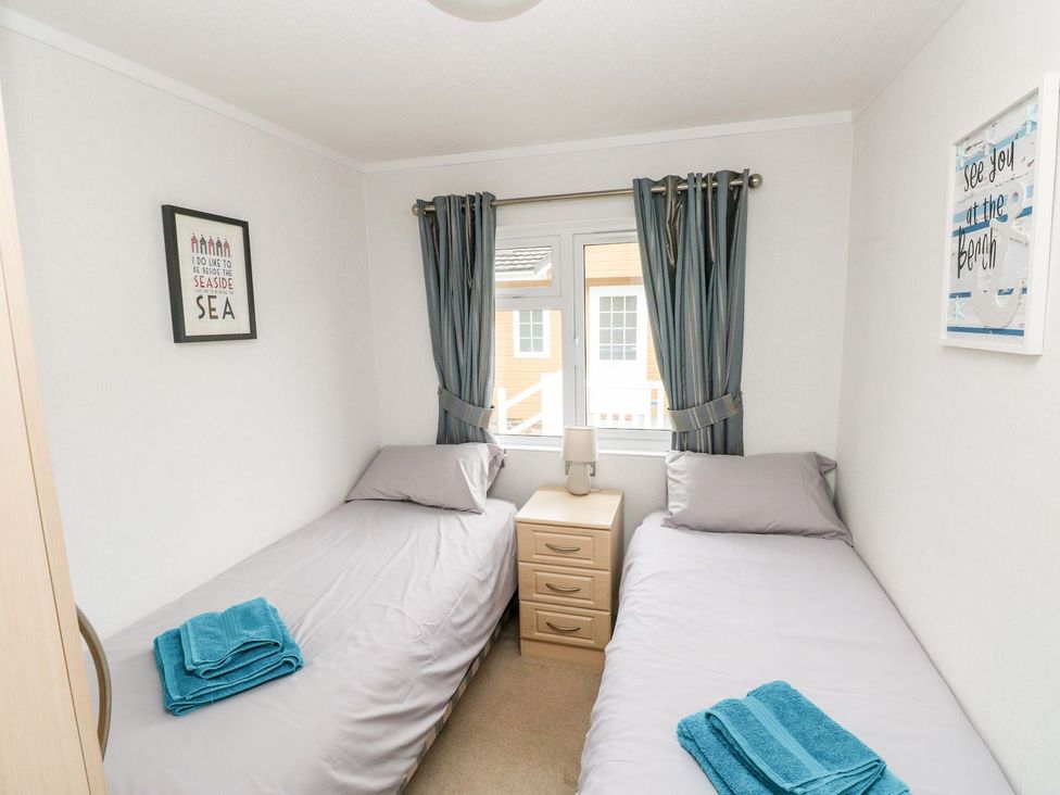 A bedroom with two single beds and a bedside table at Erisa