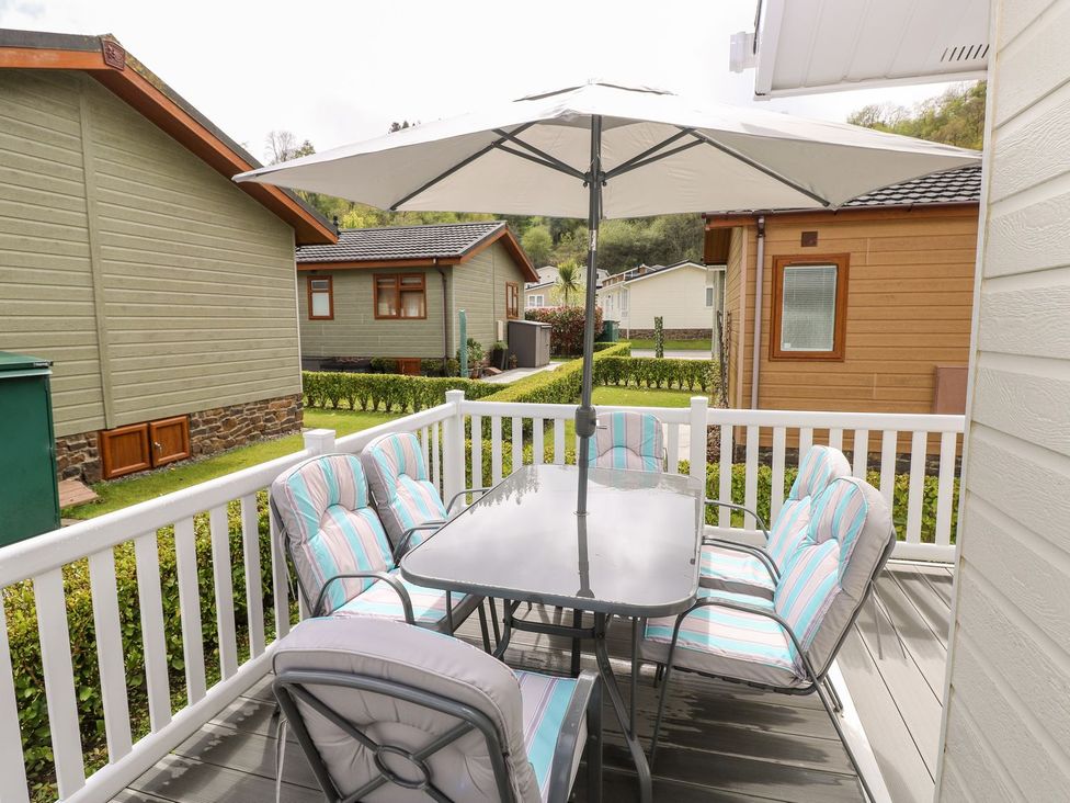An outdoor patio with a table and chairs under an umbrella at Erisa