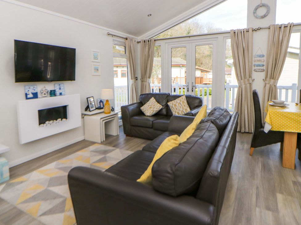 A living room with a television and sofa at Erisa in Stepaside