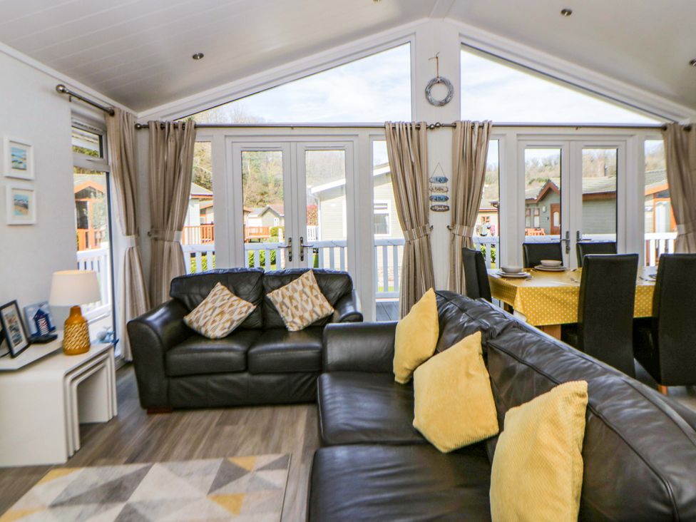 A living room with a sofa and dining area at Erisa in Stepaside