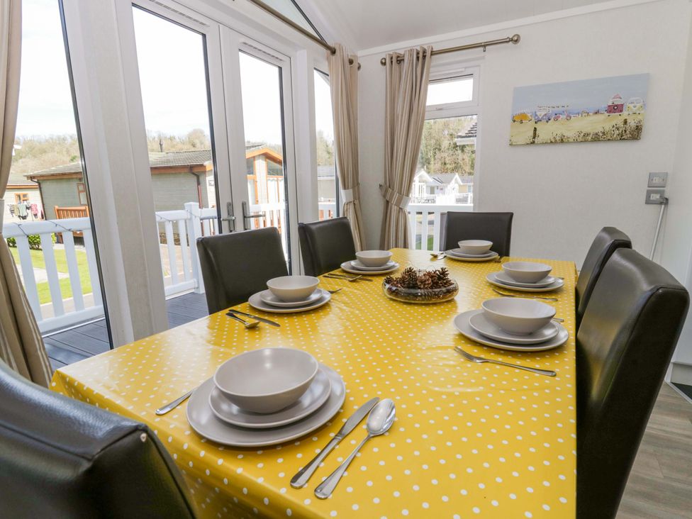 A dining room with a table set for meals at Erisa in Stepaside
