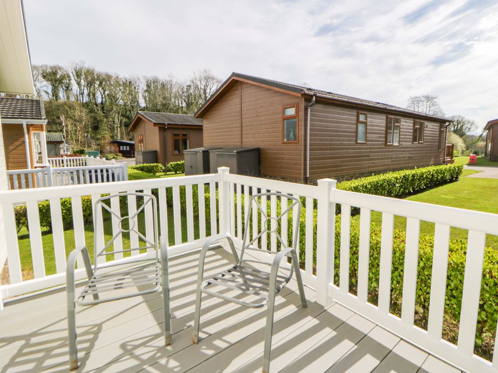 An outdoor area with chairs on a deck at Erisa in Stepaside