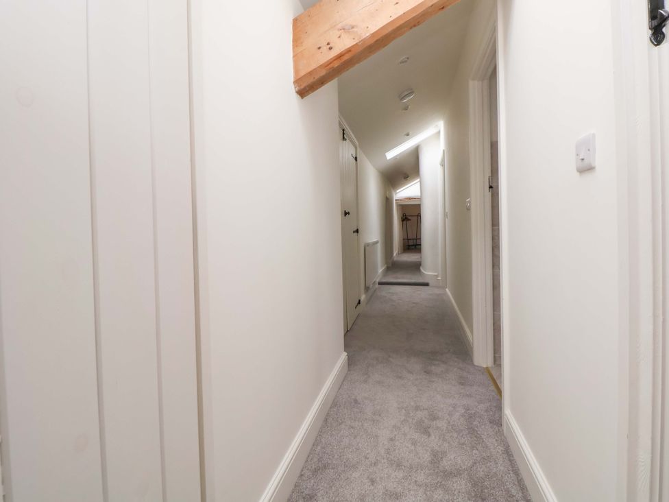 A hallway with doors and lighting at Isfryn 