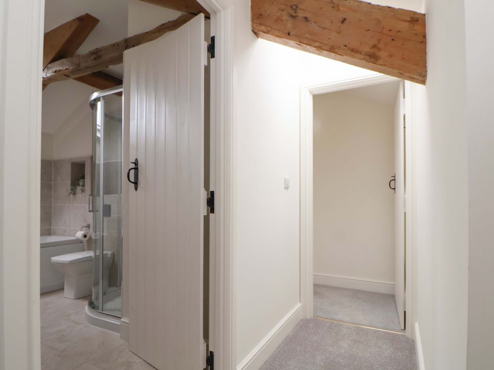 A bathroom with a shower and bathtub at Isfryn
