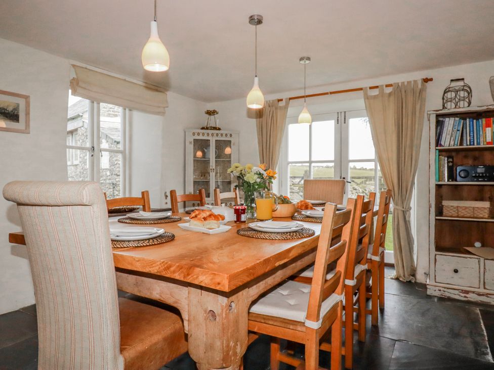 A dining room with a wooden table and chairs at Poldue House Watergate near Camelford