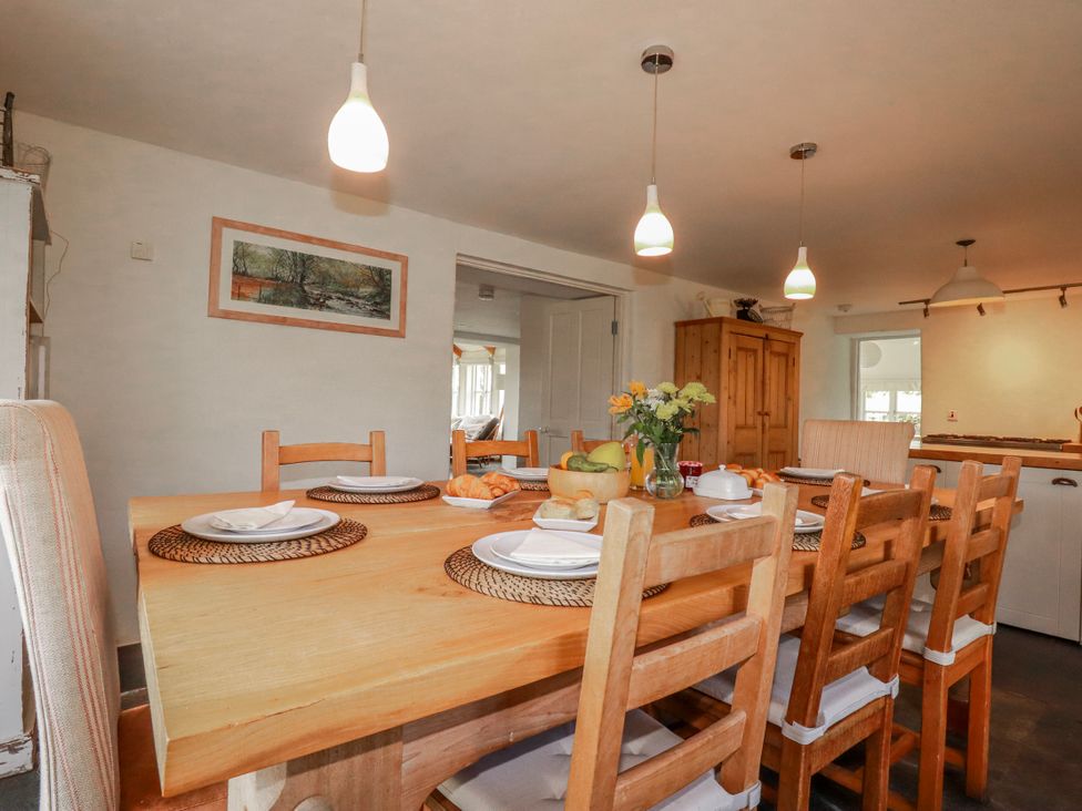 A dining room with a wooden table and chairs at Poldue House Watergate near Camelford