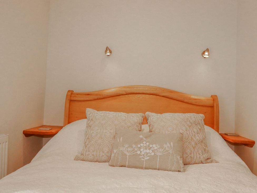 A bedroom with a bed and pillows at Poldue House Watergate near Camelford