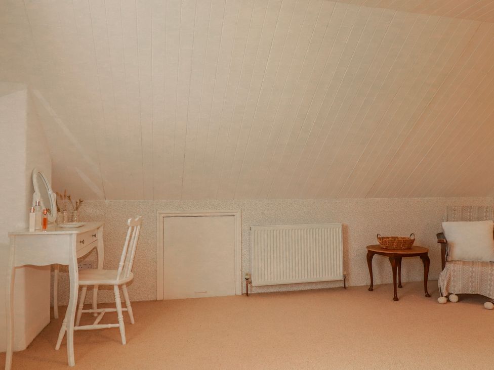 An attic with a vanity table and chair at Poldue House Watergate near Camelford