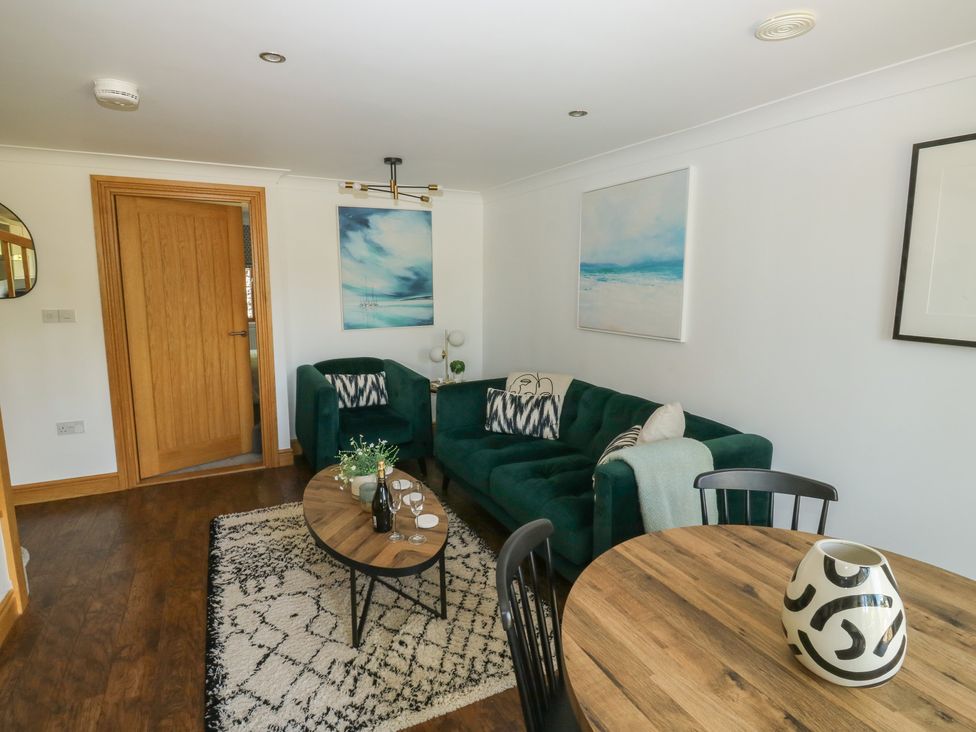 A living room with a sofa and coffee table at 2 Court Cottage in Dartmouth