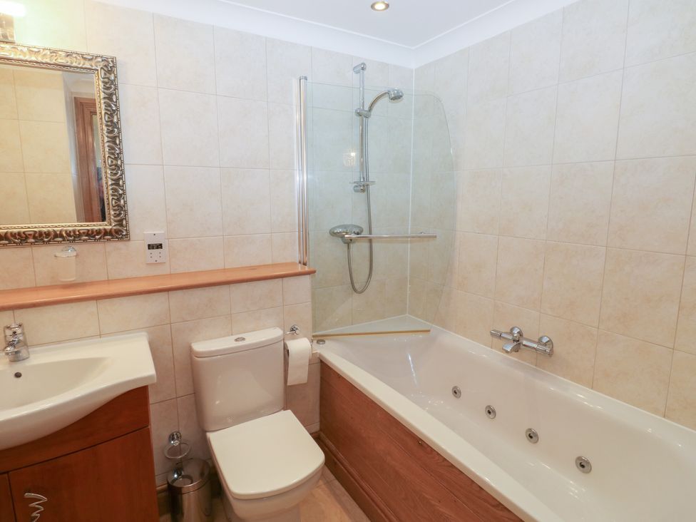 A bathroom with a sink, toilet, shower, and bathtub at 2 Court Cottage Dartmouth