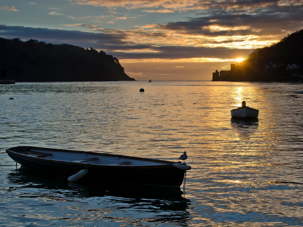 A view of boats in water during sunset at 2 Court Cottage, Hillfield Village Dartmouth