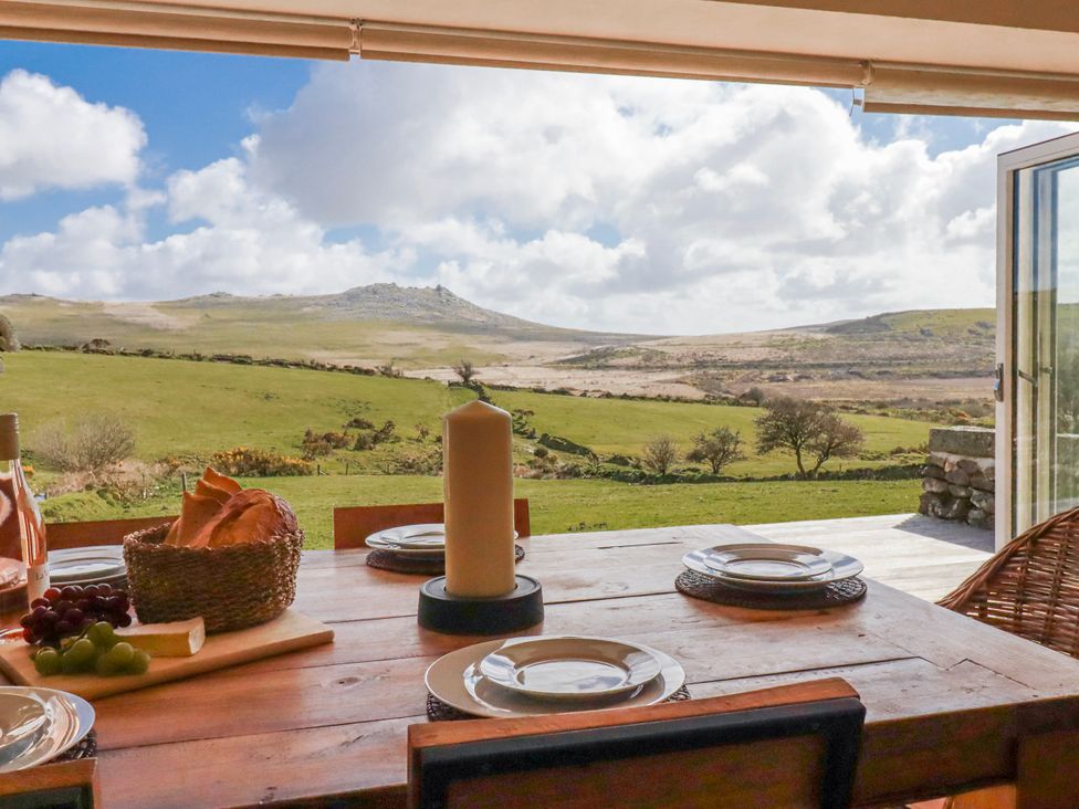 A dining table with plates and bread at Roughtor Barn Poldue near Camelford