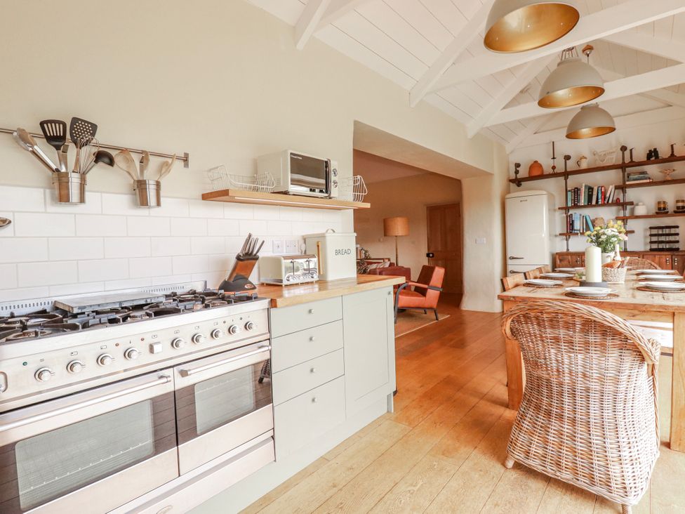 A kitchen with a stove and dining area at Roughtor Barn Poldue near Camelford