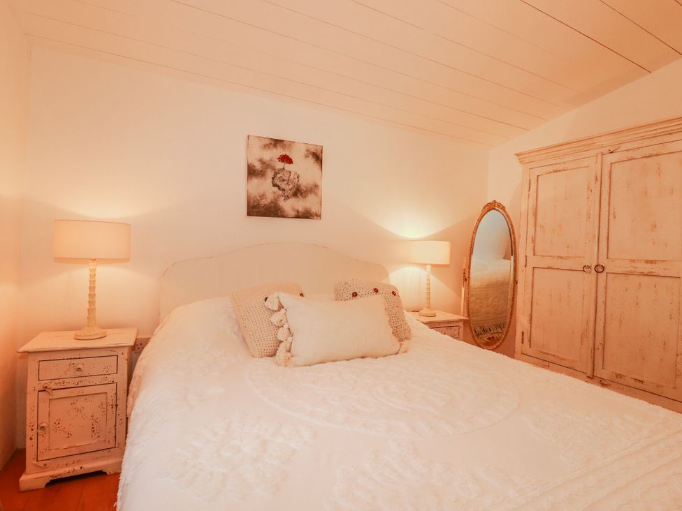 A bedroom with a bed and bedside table at Roughtor Barn Poldue near Camelford