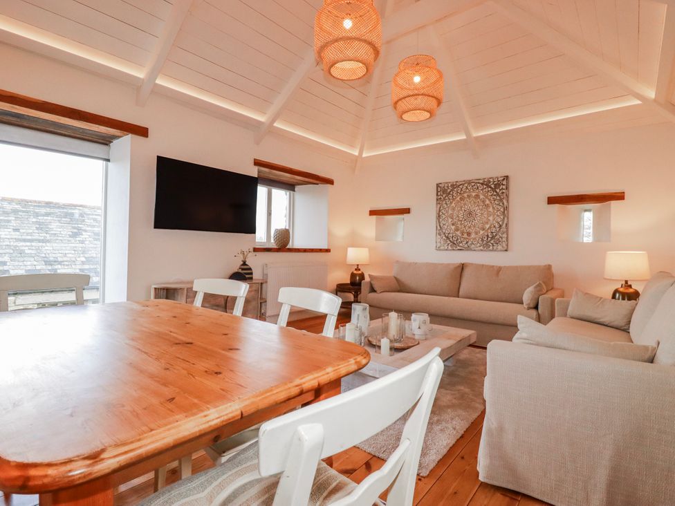 A living room with a television and seating area at Logan Barn in Poldue near Camelford
