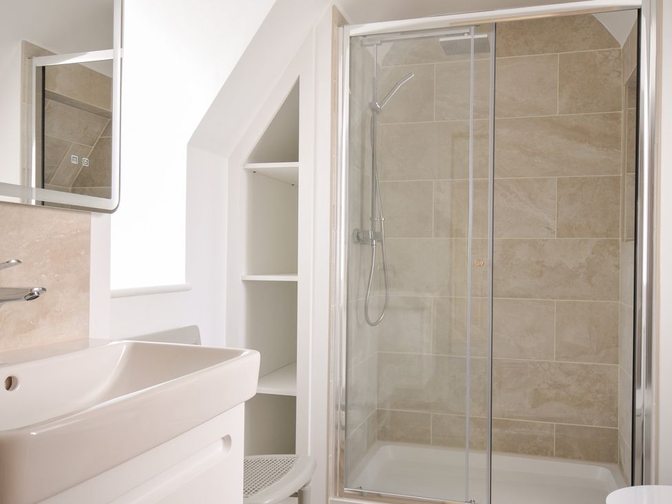 A bathroom with a shower and sink at Seaworthy in Daymer Bay