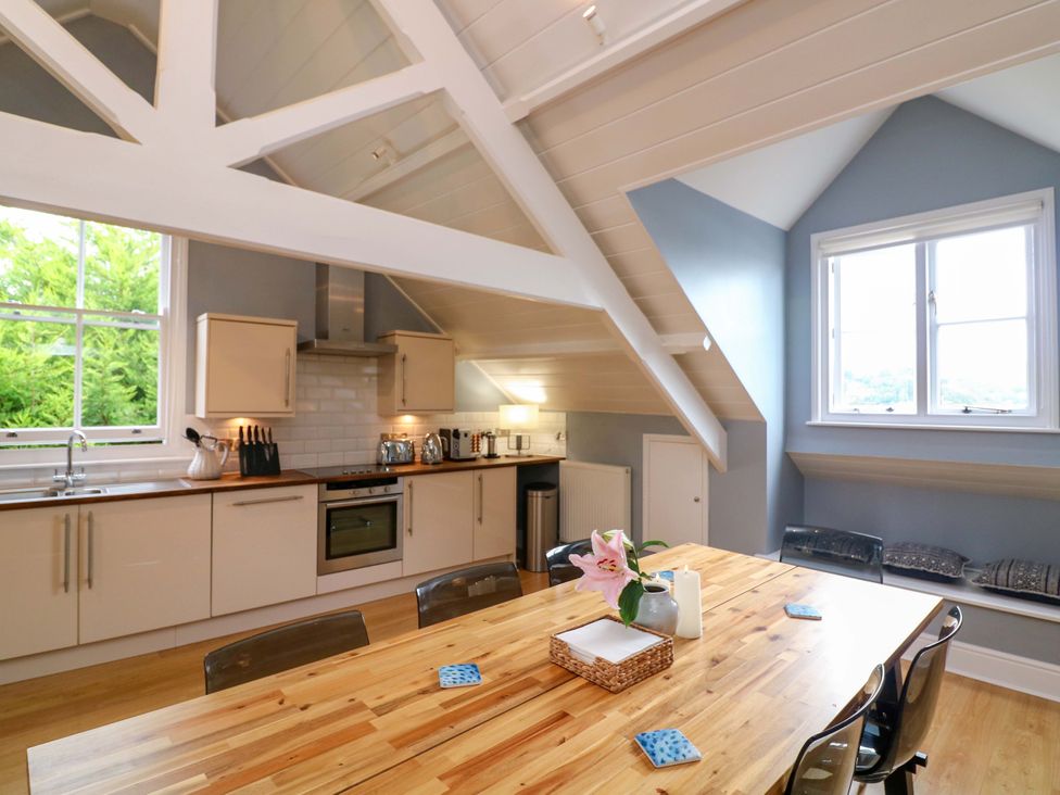 A kitchen with a dining table and chairs at 2 The Old School House in 