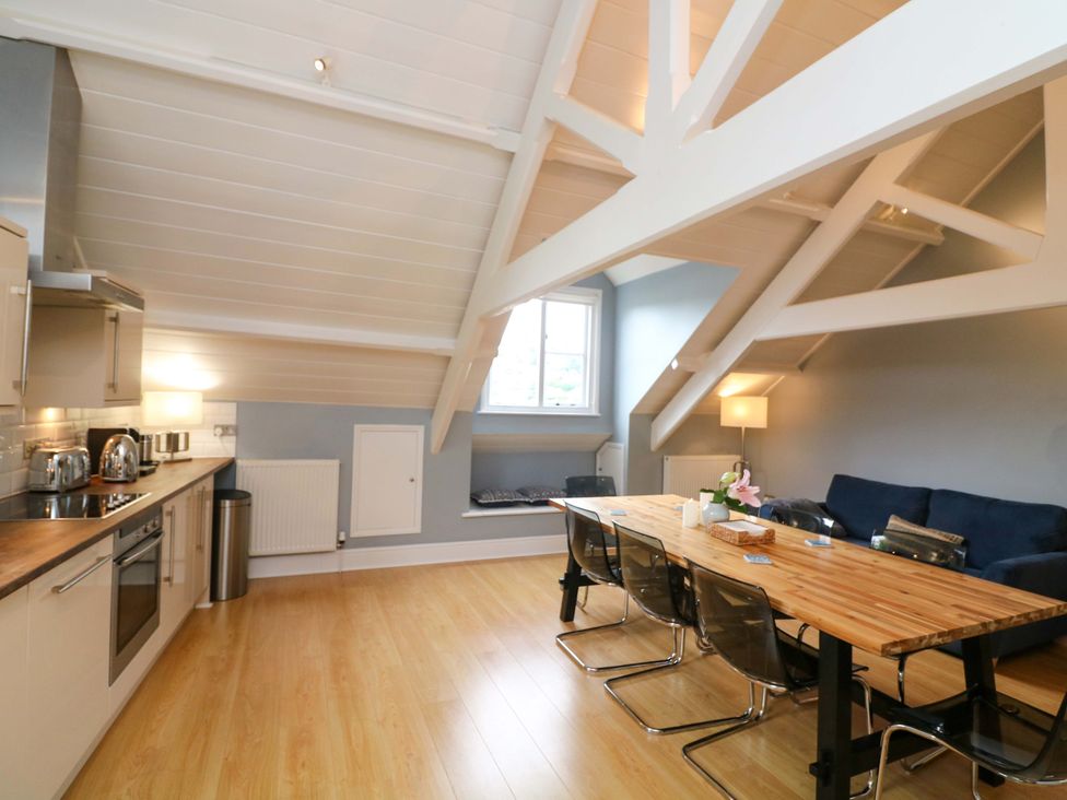 A living room with a kitchen and dining area at 2 The Old School House in 