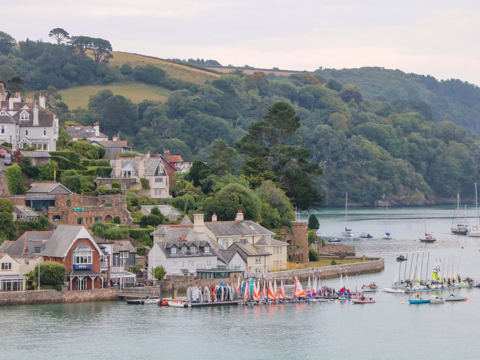 A view of houses and boats by the water at 2 The Old School House