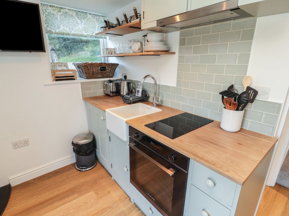A kitchen with a sink and appliances at Wren's Nest Thornthwaite near Braithwaite