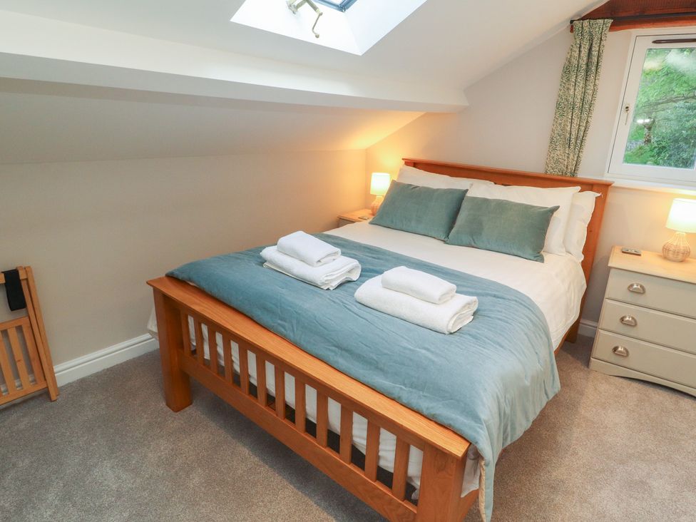 A bedroom with a bed and dresser at Wren's Nest Thornthwaite near Braithwaite
