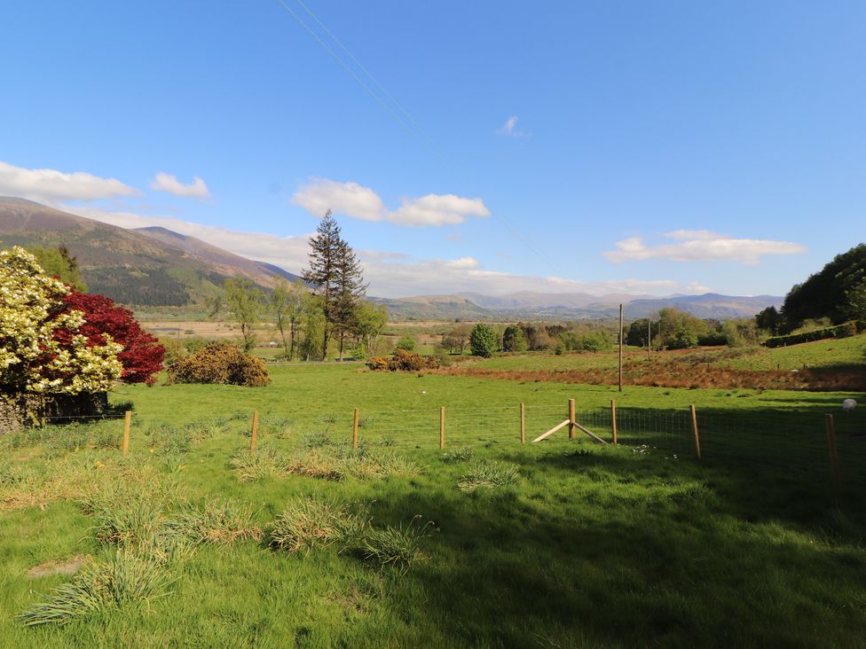 A scenic view of mountains and trees at Wren's Nest in Thornthwaite near Braithwaite