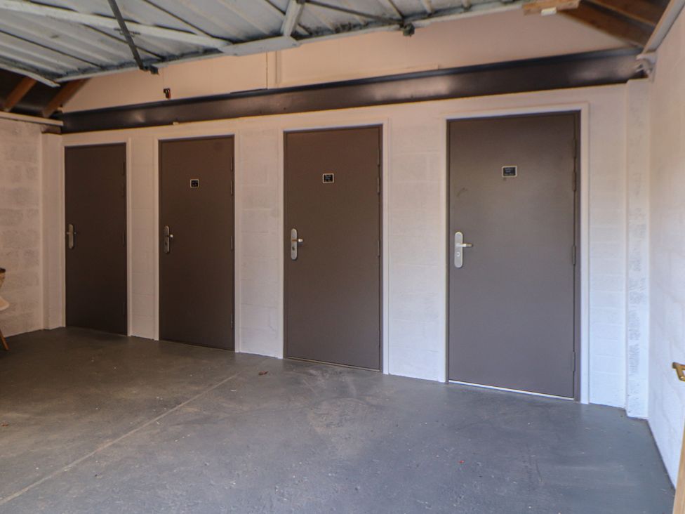 A garage with multiple closed doors at Wren's Nest Thornthwaite near Braithwaite