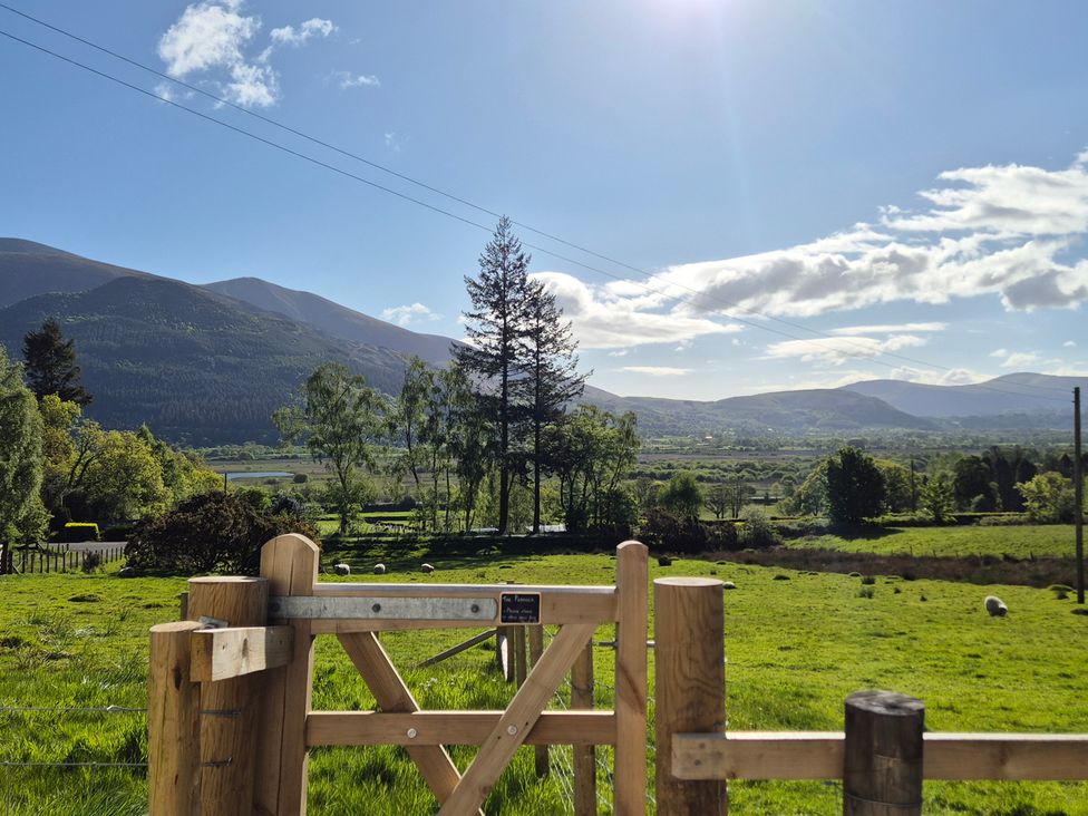 A scenic view of mountains and grassland at Wren's Nest Thornthwaite near Braithwaite